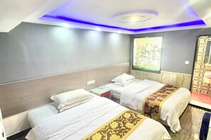 A hotel room with two beds, a nightstand, a mirror, and a ceiling with blue lighting. - Yueyi Hotel (Shanghai)