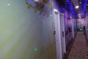 A hallway with doors on the right, a patterned carpet, and a ceiling with recessed lighting. - Yueyi Hotel (Shanghai)