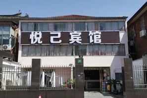 A building with a sign that reads 'Joyful Inn'. - Yueyi Hotel (Shanghai)
