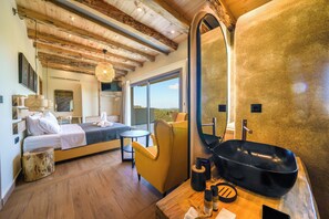 A modern bedroom with a large bed, a wooden ceiling, a round mirror, and a view of the outdoors. - Casa Astra (Hersonissos)