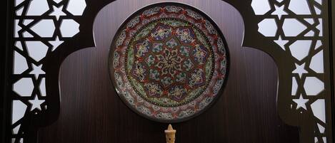 A decorative wooden partition with a central circular design and star-shaped cutouts.