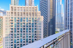 A high-rise building with multiple balconies, large windows, and a modern architectural design. - bnbme | Stand Point Tower A | 1BR + Study Room (Dubai)