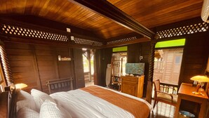 A wooden room with a bed, a television, a desk, and a chair. - Landmark Cenang (Langkawi)