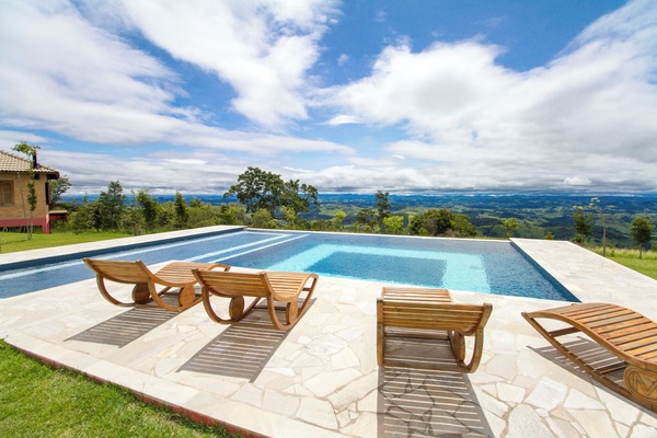 Outdoor pool, open 10:00 AM to 5:00 PM, pool umbrellas