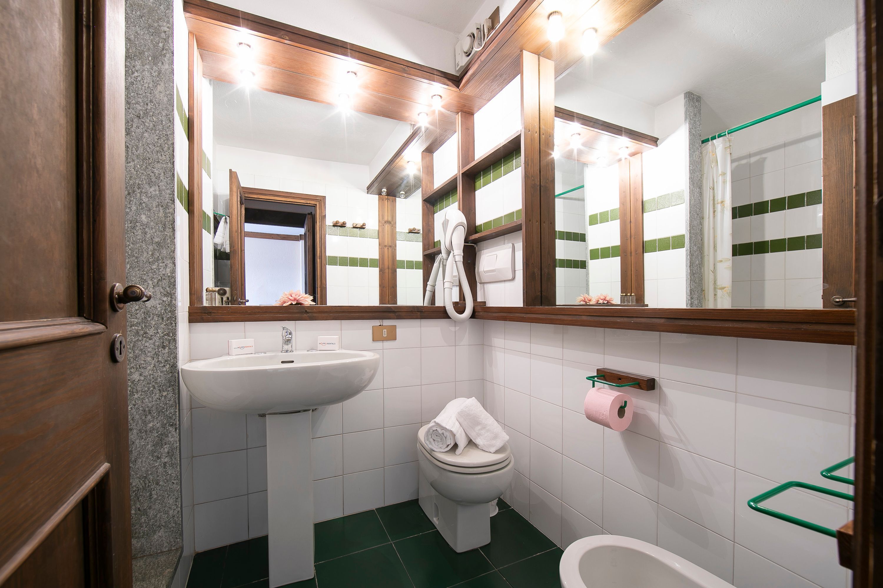 A bathroom with a white sink, a toilet, and a bathtub.
