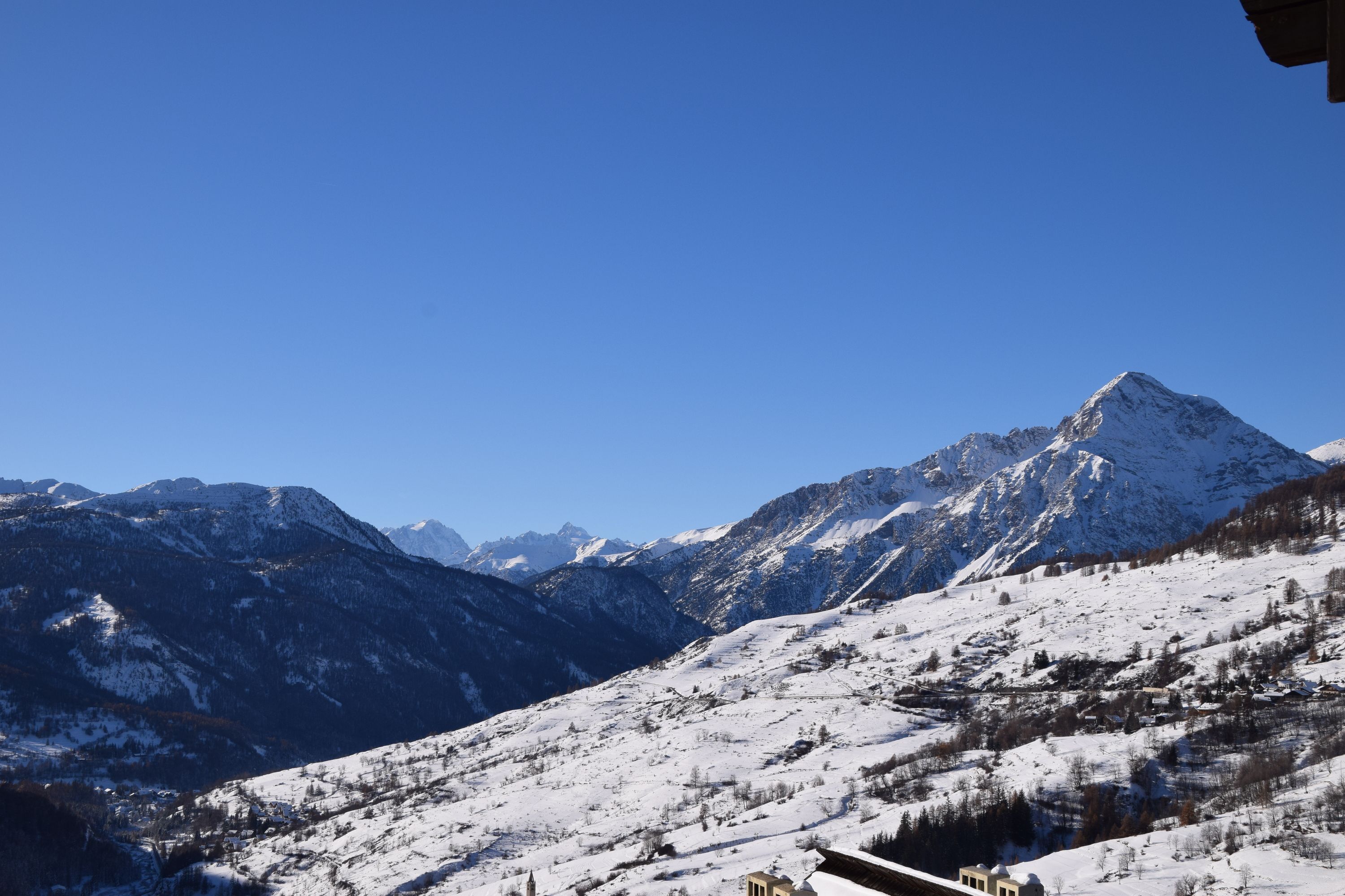 A snow-covered mountain landscape with a clear sky.