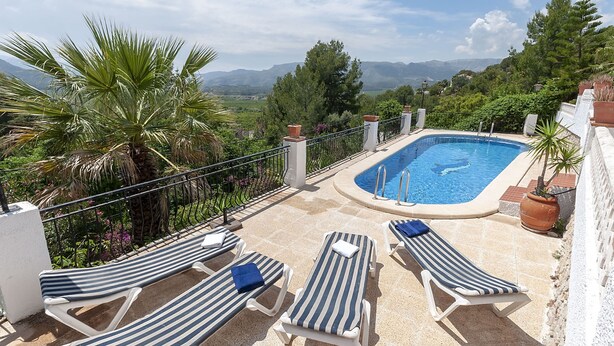 A rooftop pool with four striped lounge chairs and a view of the surrounding landscape. - Casabra in Ador With 5 Bedrooms and 3 Bathrooms (Palma de Gandia)