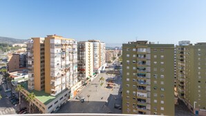 A high-rise residential building with multiple balconies, a central courtyard, and a clear view of the surrounding urban area. - La Caracola in Torremolinos (Torremolinos)