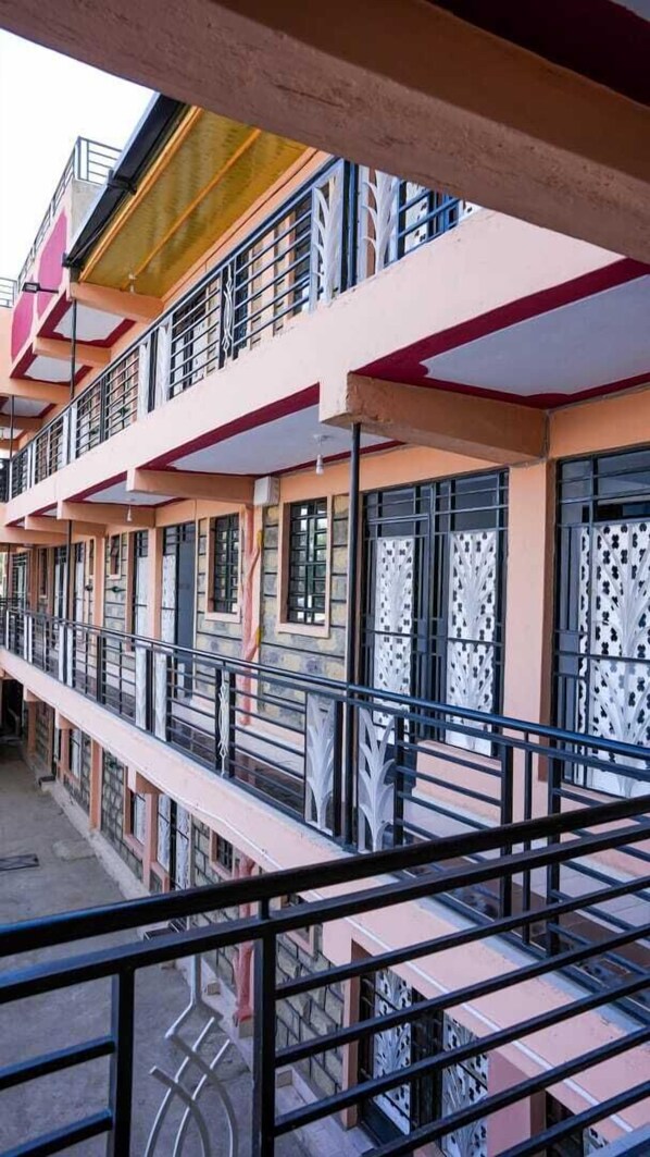 A multi-story building with balconies, railings, and patterned window designs. - Lux Suites Tara Smart Homes Naivasha (Naivasha)