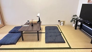 A room with tatami flooring, a low table with a lamp, a sofa, and a television. - Tabitime Oimasato Kiki 7min to Namba / 2min to Station /70 sqm house (Osaka)