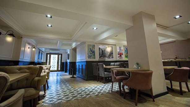 A spacious restaurant with high ceilings, recessed lighting, and a patterned floor. - Comfort Home Taksim (Istanbul)