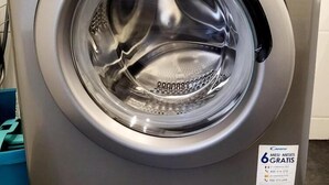 A front view of a Candy SmartTouch washing machine with a digital display and a control knob. - Floridsdorfer Apartment (Vienna)