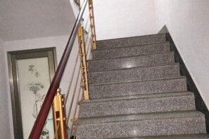A staircase with a handrail and a framed picture on the wall. - nqkz (Wuyuan)