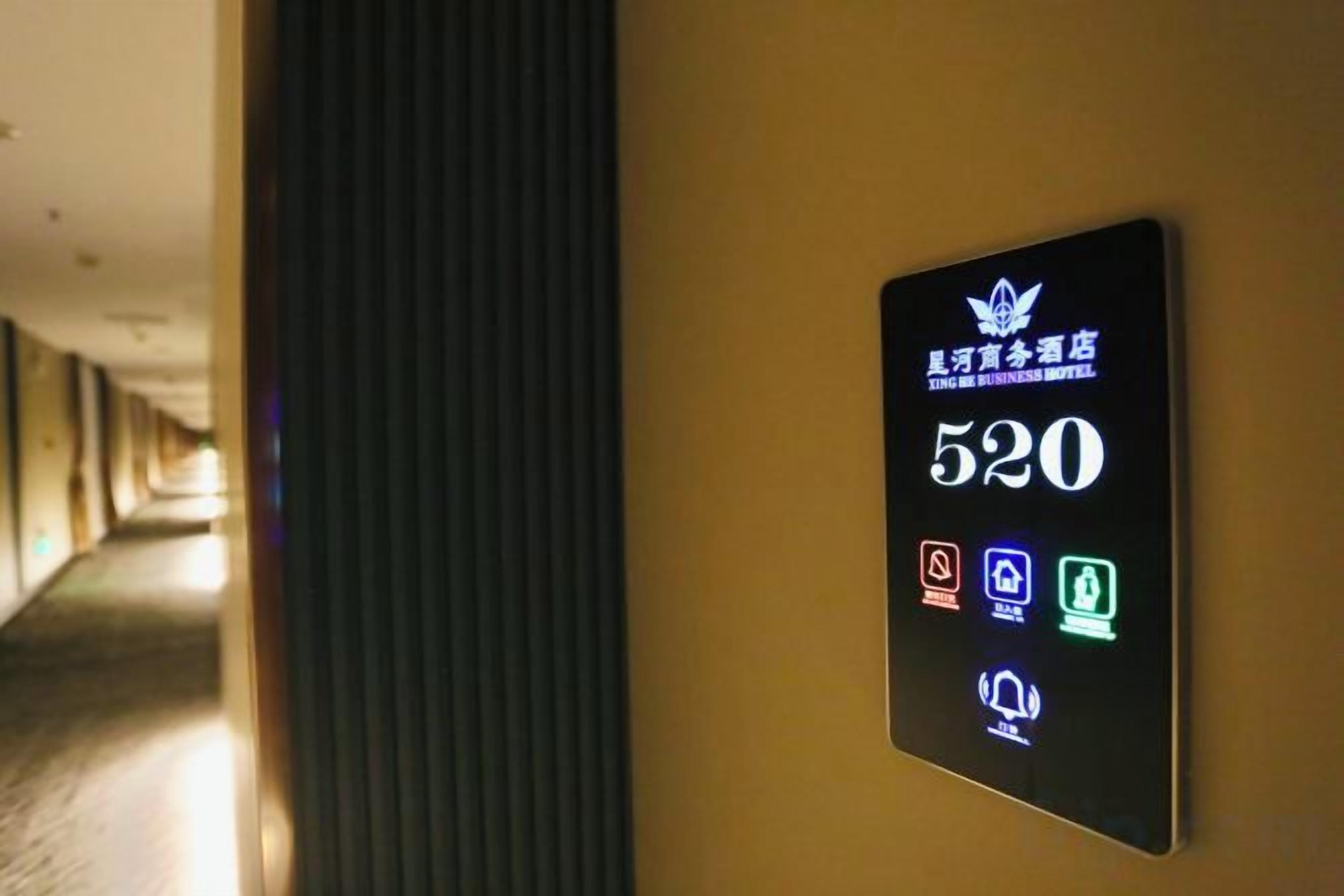 A hotel room number sign with icons indicating amenities such as a bed, a shower, and a toilet.