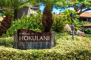 A welcome sign for Hokulani, featuring amenities like Aina Gourmet Market, Duke's Beach House, and Ho'ola Spa. - Honua Kai Ocean View 3Bedroom 3Bath (Lahaina)