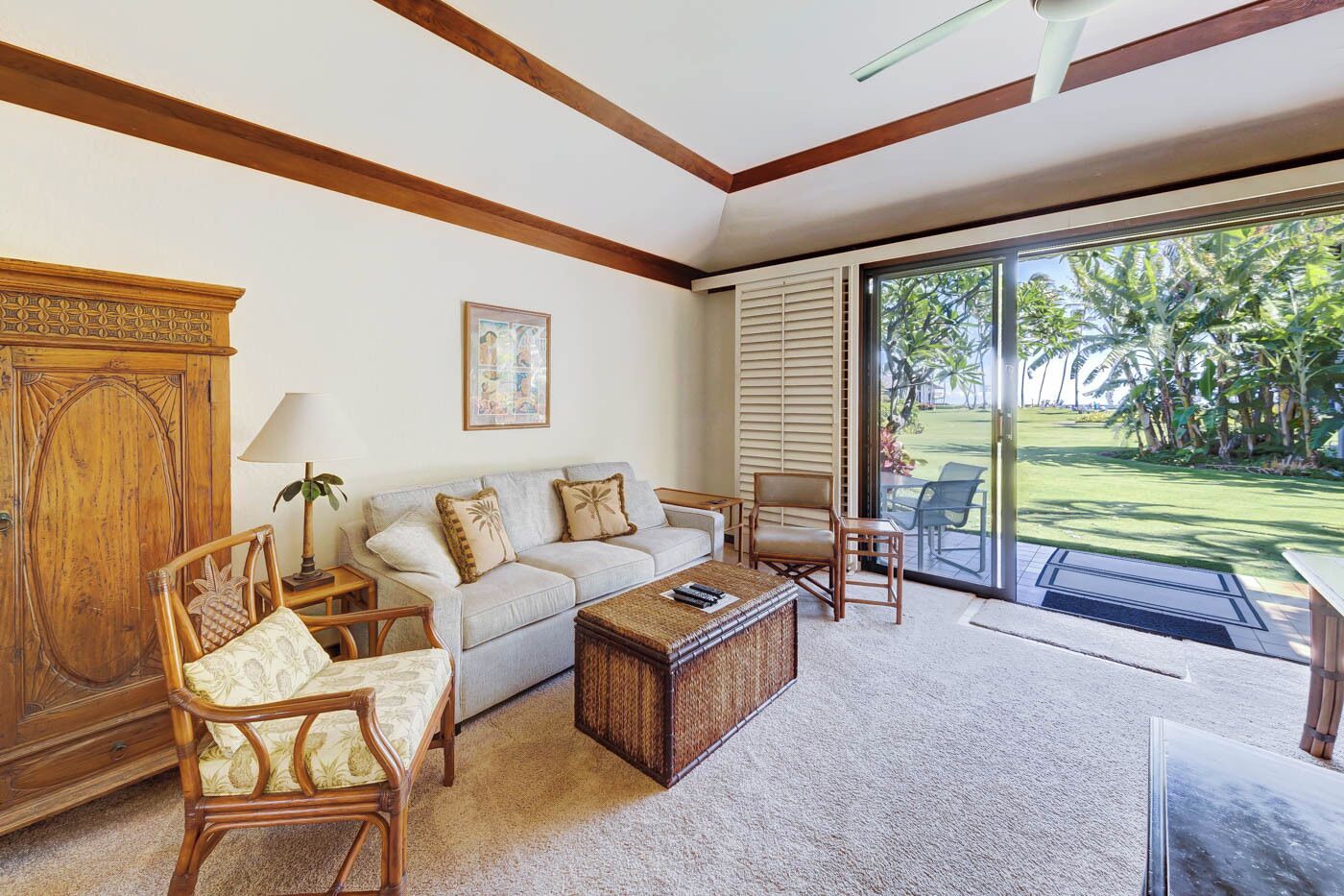A living room with a sofa, chairs, a coffee table, and a wooden cabinet.