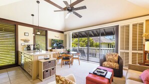 A spacious living area with a kitchen, dining table, and seating.