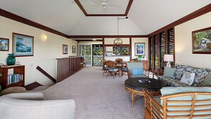 A spacious living area with a high ceiling, a dining table with chairs, a sofa, and a coffee table. - Kiahuna Plantation Resort Partial Ocean 2 Bedroom (Koloa)