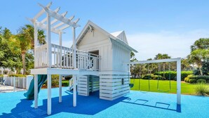 A playground with a slide and climbing structures. - Relax Awhile - Carriage House (Panama City Beach)
