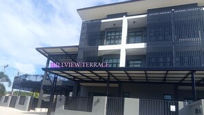 A modern building with a covered terrace area. - Hillview Terrace (Hat Yai)