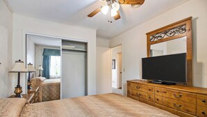 A bedroom with a bed, dresser, TV, and ceiling fan. - Crossville Calling: Fairways, Forests & Fresh Air (Crossville)