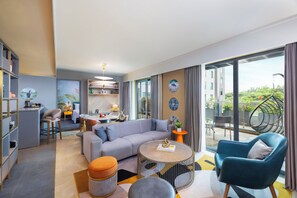 Deluxe Suite, 1 Double Bed, Balcony | Living area | 50-inch Smart TV with cable channels, books - Ibis Styles Mysuru (Mysore)