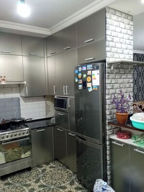 Fridge, microwave, electric kettle, cookware/dishes/utensils