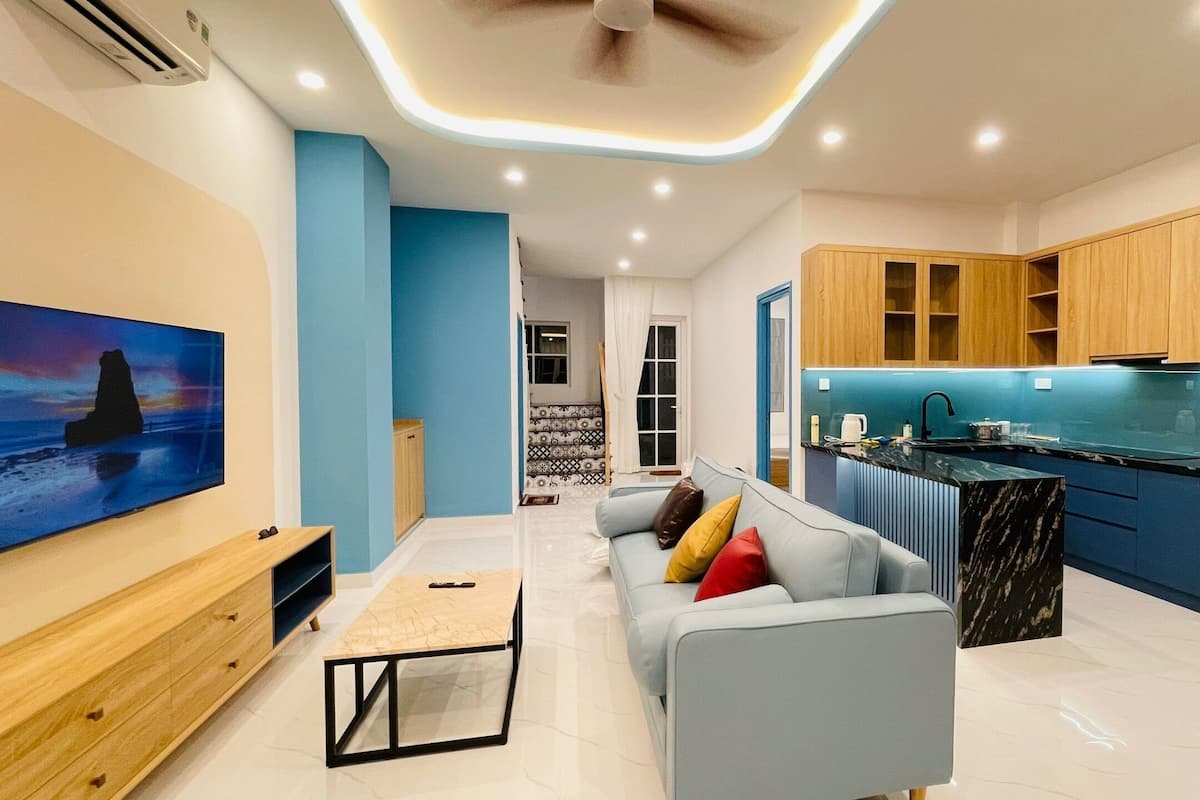 A modern apartment with a living room, kitchen, and dining area.