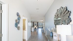 A modern hallway with a kitchen area visible in the background, featuring a dining table and chairs. - Special Offer! Lake View with Private Pool, SPA, Family-Friendly 489OC (Kissimmee)