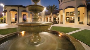 A fountain in a courtyard with a building in the background. - Special Offer! Lake View with Private Pool, SPA, Family-Friendly 489OC (Kissimmee)