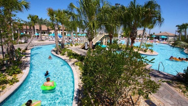 A resort pool area with multiple swimming pools, palm trees, and lounge chairs. - Special Offer! Lake View with Private Pool, SPA, Family-Friendly 489OC (Kissimmee)