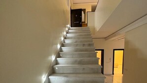 A staircase with a modern design, leading to a second floor.