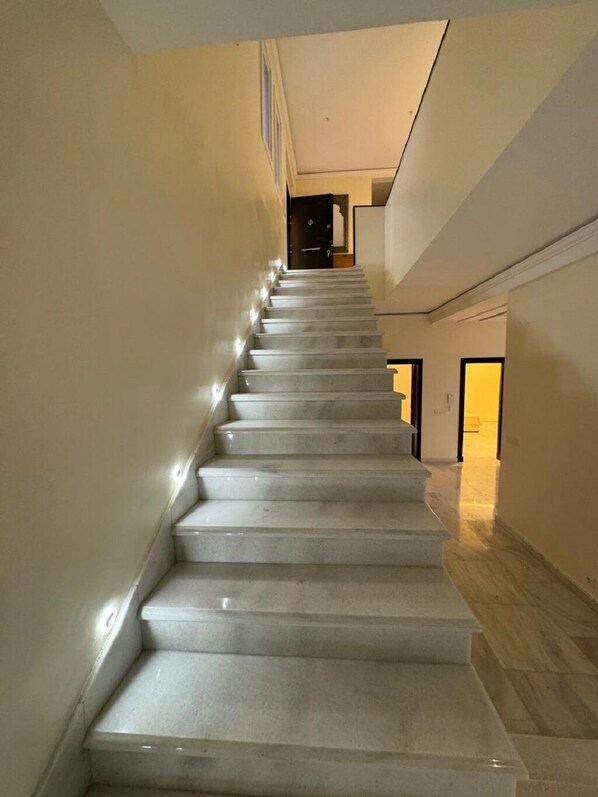 A staircase with a modern design, leading to a second floor. - Villa Beni Mejmel Tangier (Tanger)