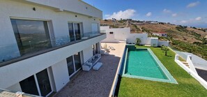 A modern house with a rooftop pool, a covered patio, and a view of the surrounding landscape. - Villa Beni Mejmel Tangier (Tanger)