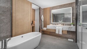 Enjoy a relaxing soak in the bathtub and get ready for the day at the dual vanity with a large mirror.