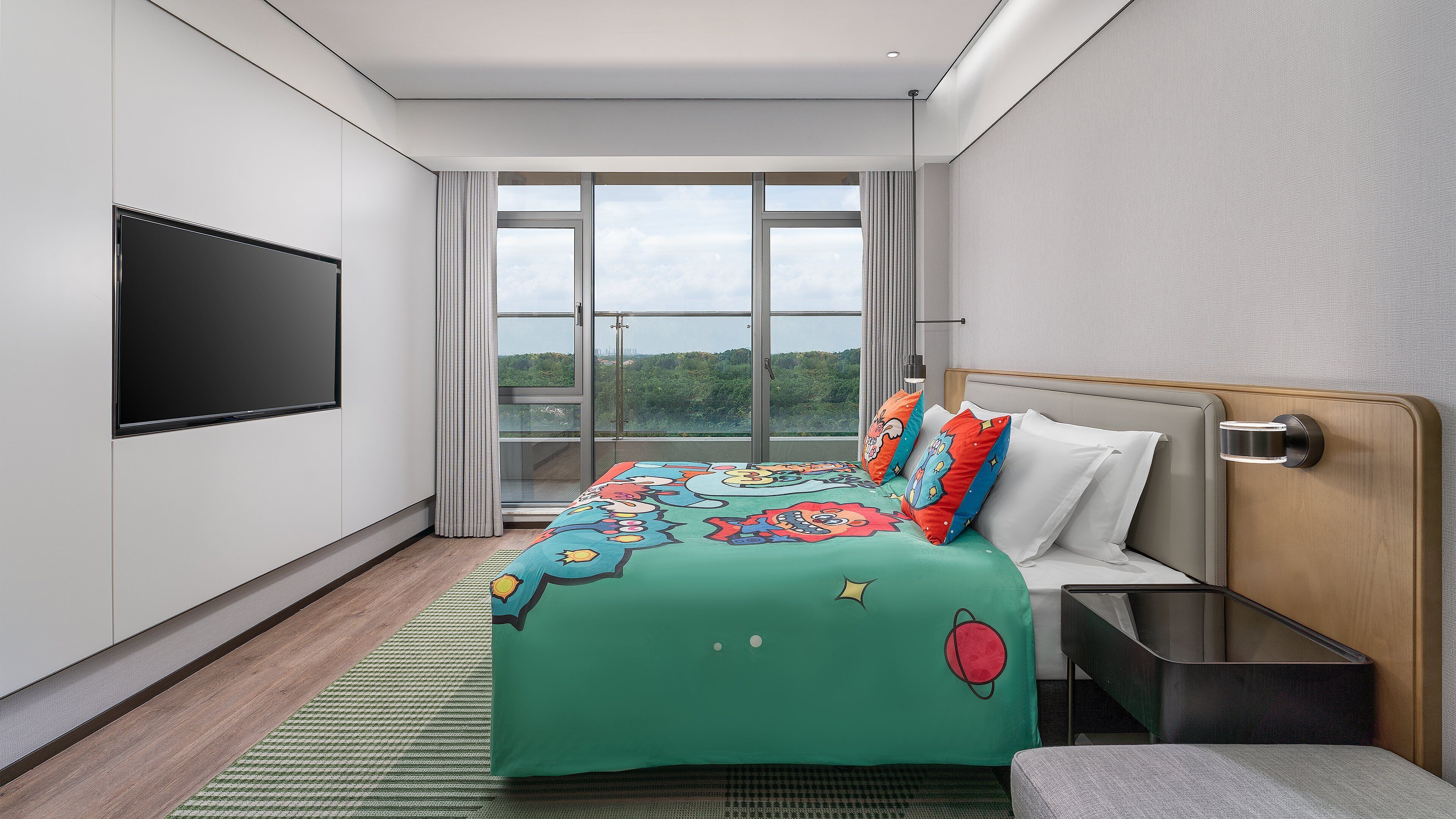A modern hotel room with a large bed, a flat-screen TV, and a view of the outdoors.