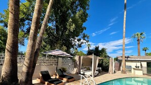 A poolside area with lounge chairs, a covered seating area, and a barbecue grill. - Arcadia oasis Heated Pool (Phoenix)
