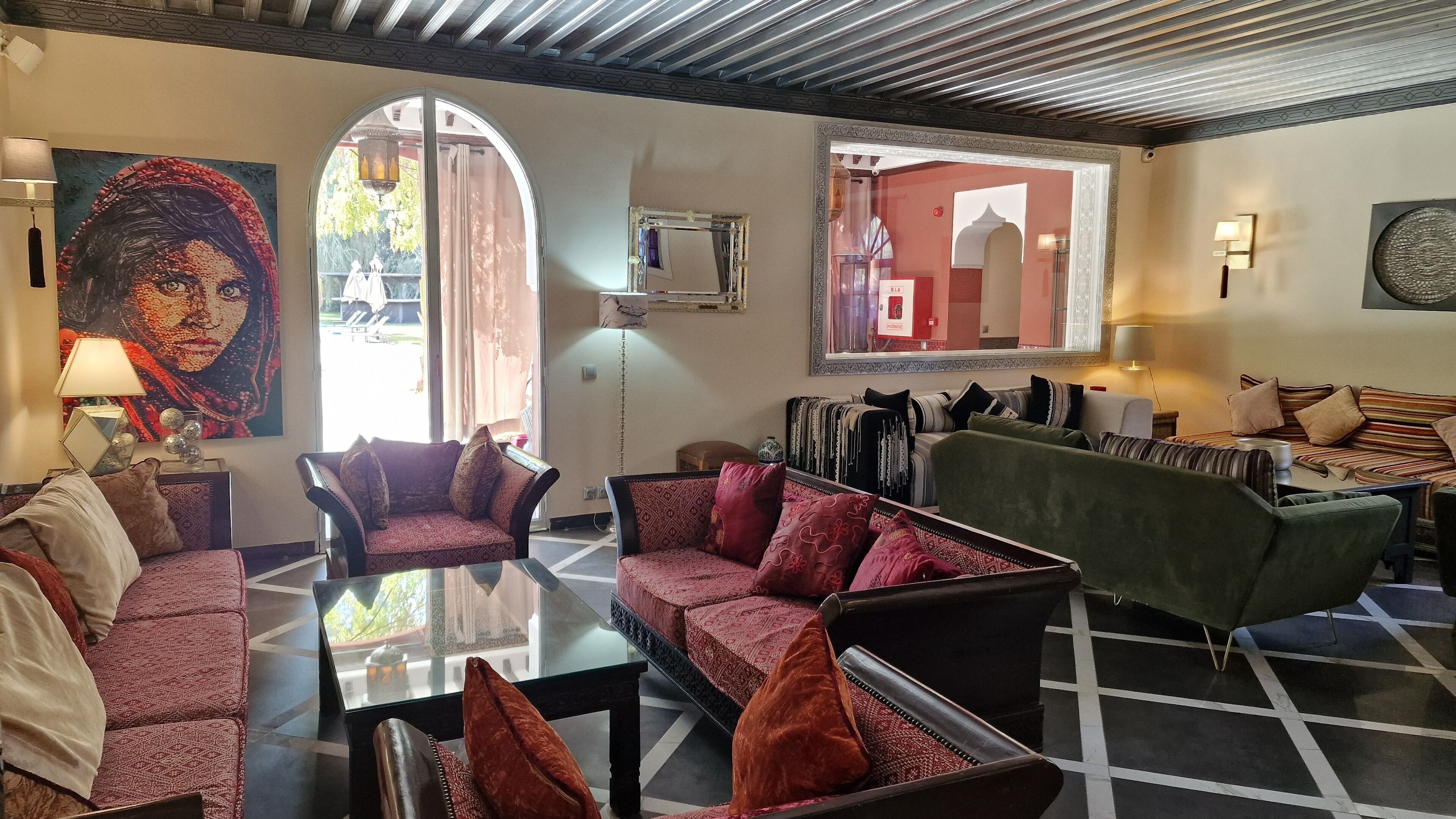 A spacious living area with multiple seating options, including sofas and armchairs, arranged around a central coffee table.