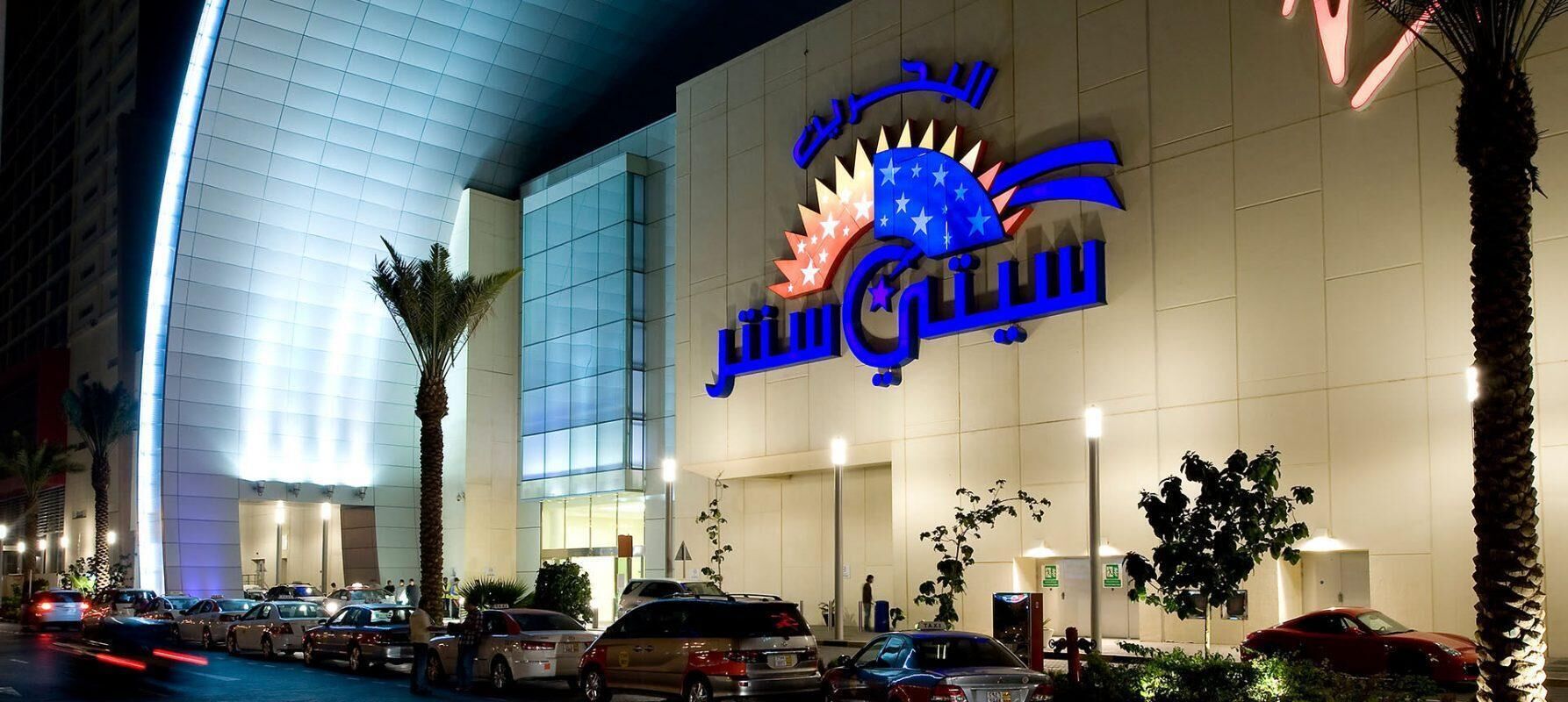 A hotel with a prominent sign featuring a star and crescent symbol, indicating it may be a hotel with a religious affiliation.