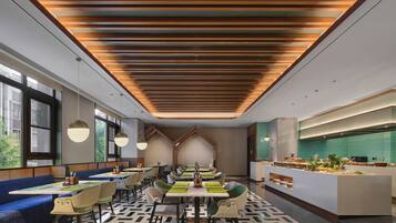 A modern restaurant with a geometric patterned floor, wooden slatted ceiling, and a central island with a display of fruits and flowers.