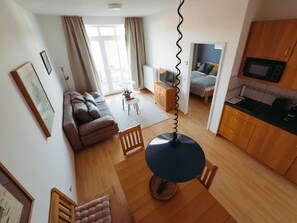 A modern apartment with a living room, dining area, and kitchen. - Vacation apartment "Ammersee" at Andechs Monastery (Andechs)