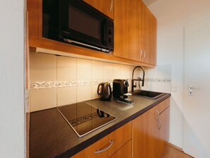 Fridge, microwave, stovetop, coffee/tea maker