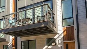 A modern multi-story residential building with a balcony, large windows, and a clean, contemporary design. - Luxury Escape | Spacious & Safe, 7min to Downtown! (Nashville)