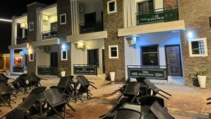 A multi-story hotel with outdoor seating and signage for 'Westmac'. - Spirit of India Lagos (Lagos)