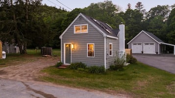 A two-story house with a garage, a front porch, and a driveway.