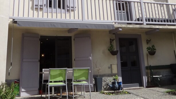 A two-story building with a balcony, a door, and a window. - Spacious 5-bedroom house in enchanting Luz-Saint-Sauveur 
 (Luz-Saint-Sauveur)
