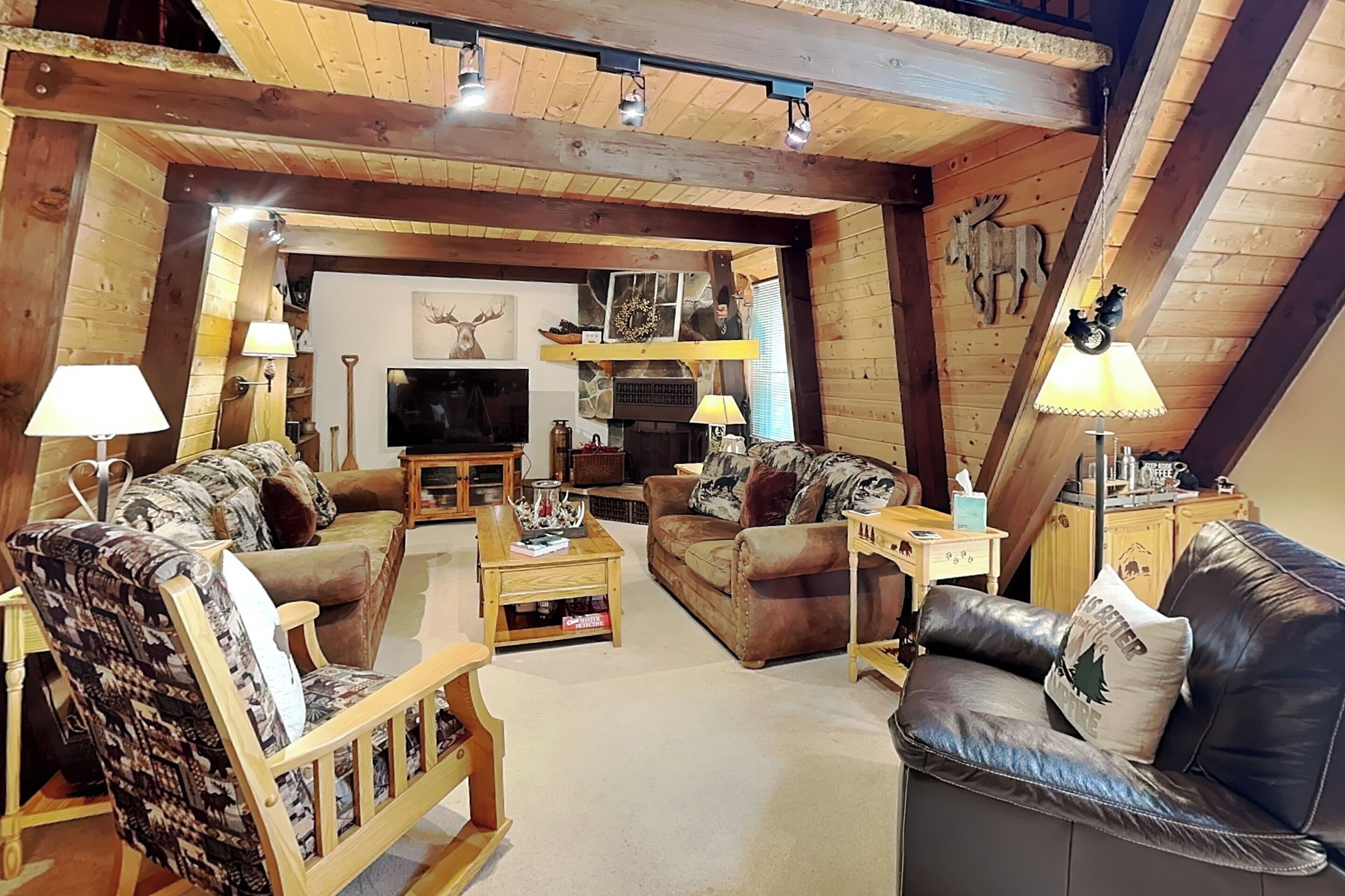 A cozy living room with wooden furniture, a fireplace, and a television.