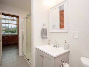 Shower, hair dryer, towels, soap - Jennifer’s Historic Loft | Glass-Enclosed Bedroom (Providence)