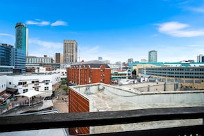 A cityscape with a variety of buildings, including a prominent red brick structure and several modern high-rises. - Stylish Arcadian Apartment - Balcony - Parking (Birmingham)