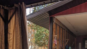 A hot tub with water flowing, surrounded by wooden walls and a covered area with a view of trees. - Big Red! Modern clubhouse with Hot Tub! Walking distance to Castle - 4 bedrooms (Stanwood)